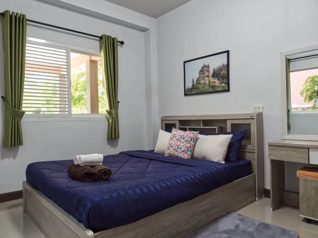 Modern Krabi rental bedroom with comfortable bedding and wardrobe
