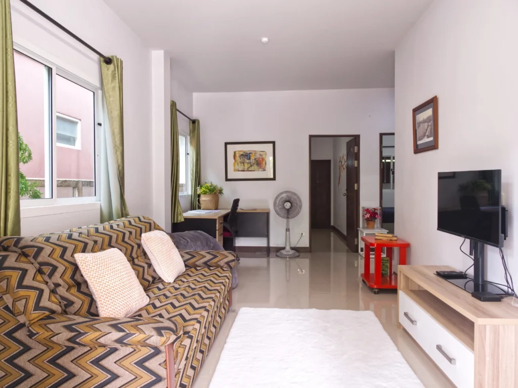 Modern Thai living room with sofa and TV in Krabi rental home