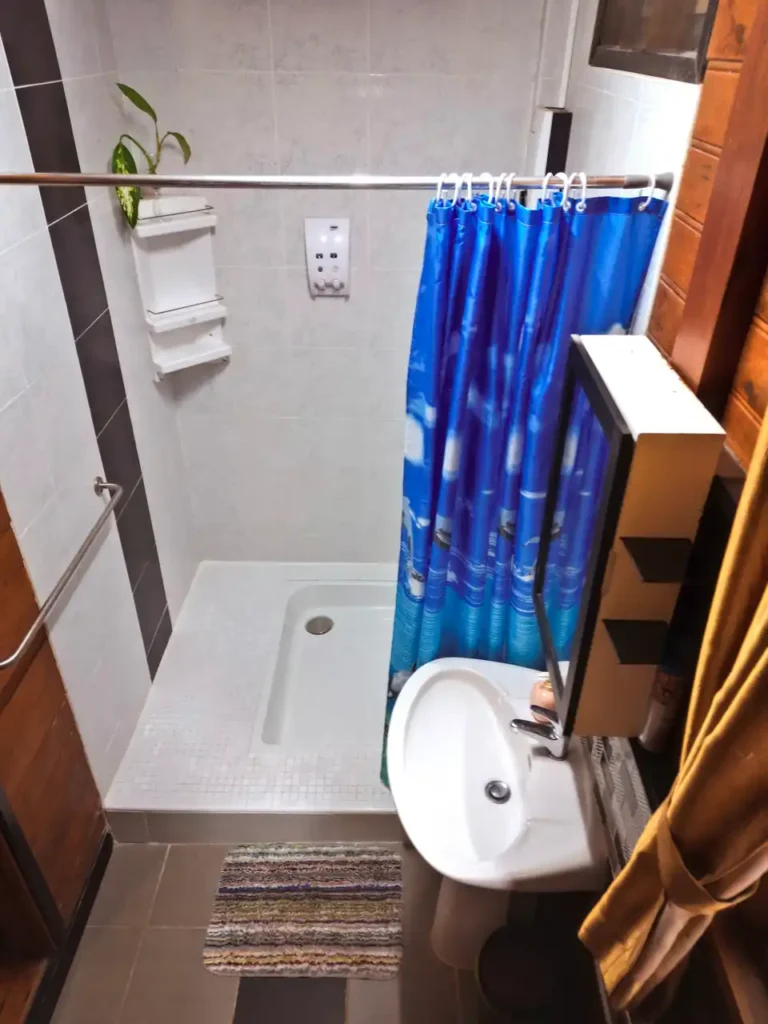 Small modern bathroom with shower and sink in Krabi teak rental home
