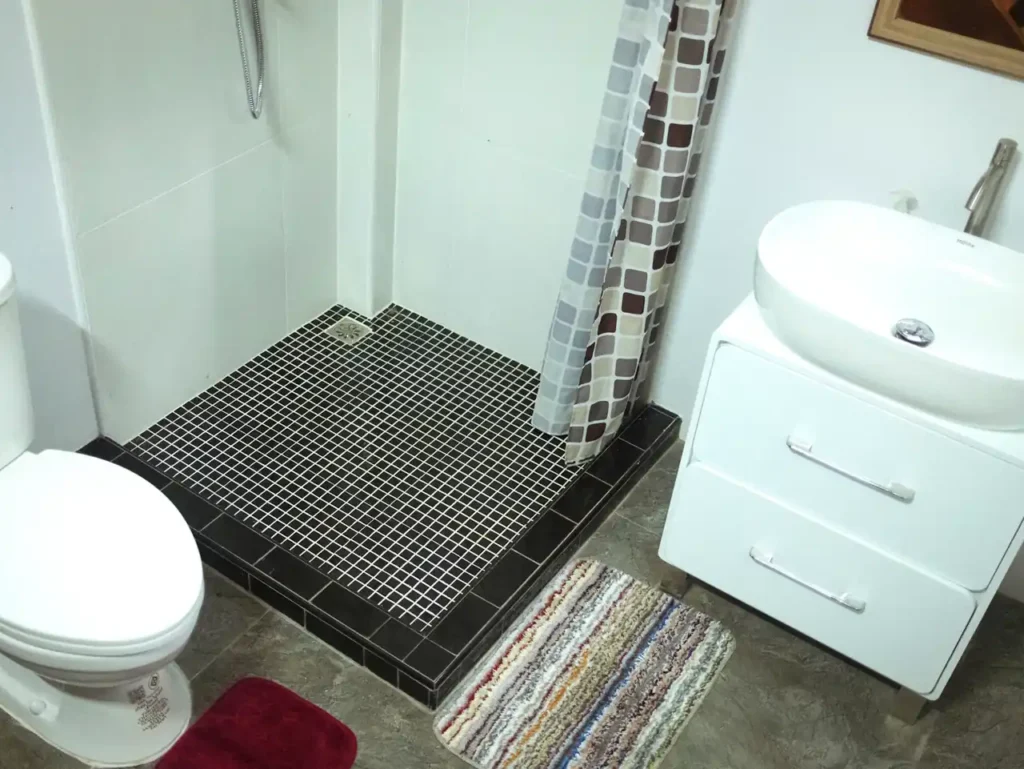 Modern Krabi rental bathroom with sink cabinet and tiled shower