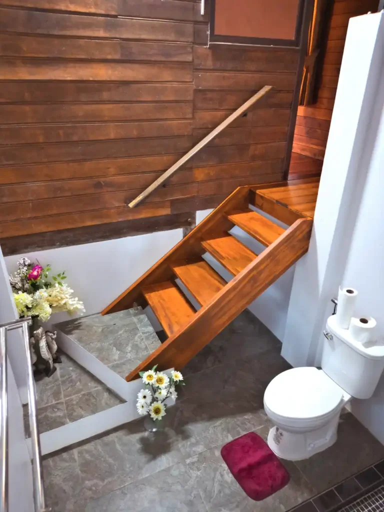 Unique Krabi teak house bathroom with staircase and rustic wooden walls