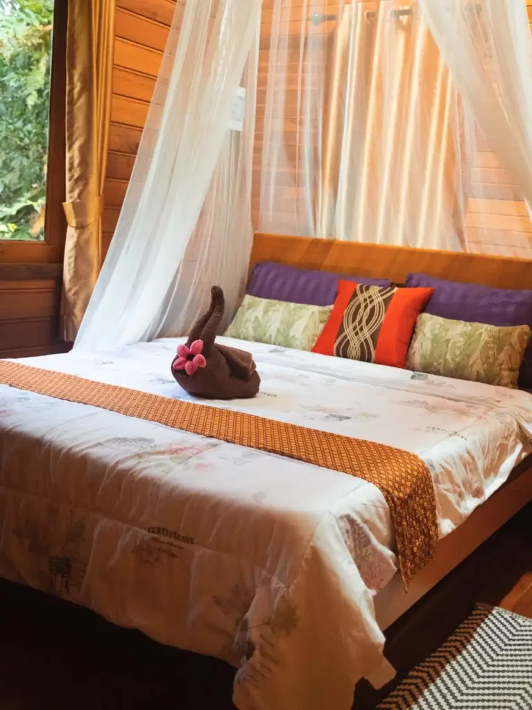 Cozy Krabi rental bedroom with canopy queen size bed and garden view