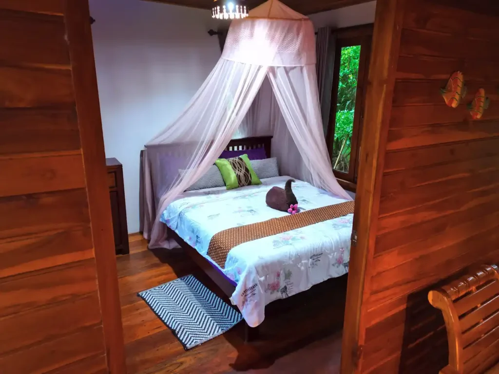 Charming Krabi rental bedroom with traditional decor and garden view