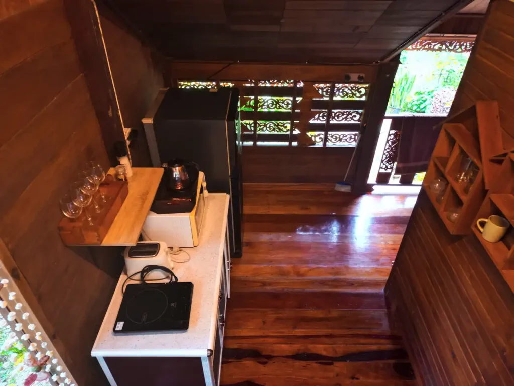 Functional Krabi teak house kitchen with rustic wooden decor and appliances